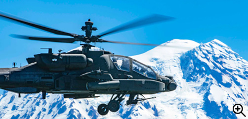 Army Col. Shane Finison flies an AH-64E Apache helicopter near Mount Rainier, Wash., July 11, 2022, during his final flight as commander of the 16th Combat Aviation Brigade.- ALLOW IMAGES