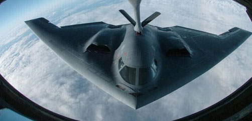 A B-2 Spirit bomber  refueling mid-flight. - ALLOW IMAGES