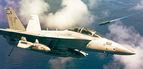 An EA-18G Growler flies above the aircraft carrier USS Ronald Reagan during operations in the Arabian Sea, Aug. 9, 2021. - ALLOW IMAGES