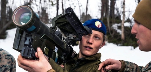 Marine Corps Lance Cpl. Dylan Pennington, right, assigned to the Aviation Combat Element, 22nd Marine Expeditionary Unit, explains the functions of the FIM-92 Stinger missile system to Norwegian army Sgt. Silje Skarsbakk during bilateral training in Setermoen, Norway, April 25, 2022.  - ALLOW IMAGES