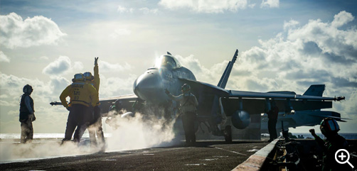Sailors signal the pilot of an F/A-18E Super Hornet before launch from the flight deck of the aircraft carrier USS Nimitz in the Philippine Sea, Dec. 27, 2022. - ALLOW IMAGES. 