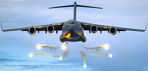 An Air Force C-17 Globemaster III deploys flares as part of a training event over the Atlantic Ocean, June 12, 2021. - ALLOW IMAGES